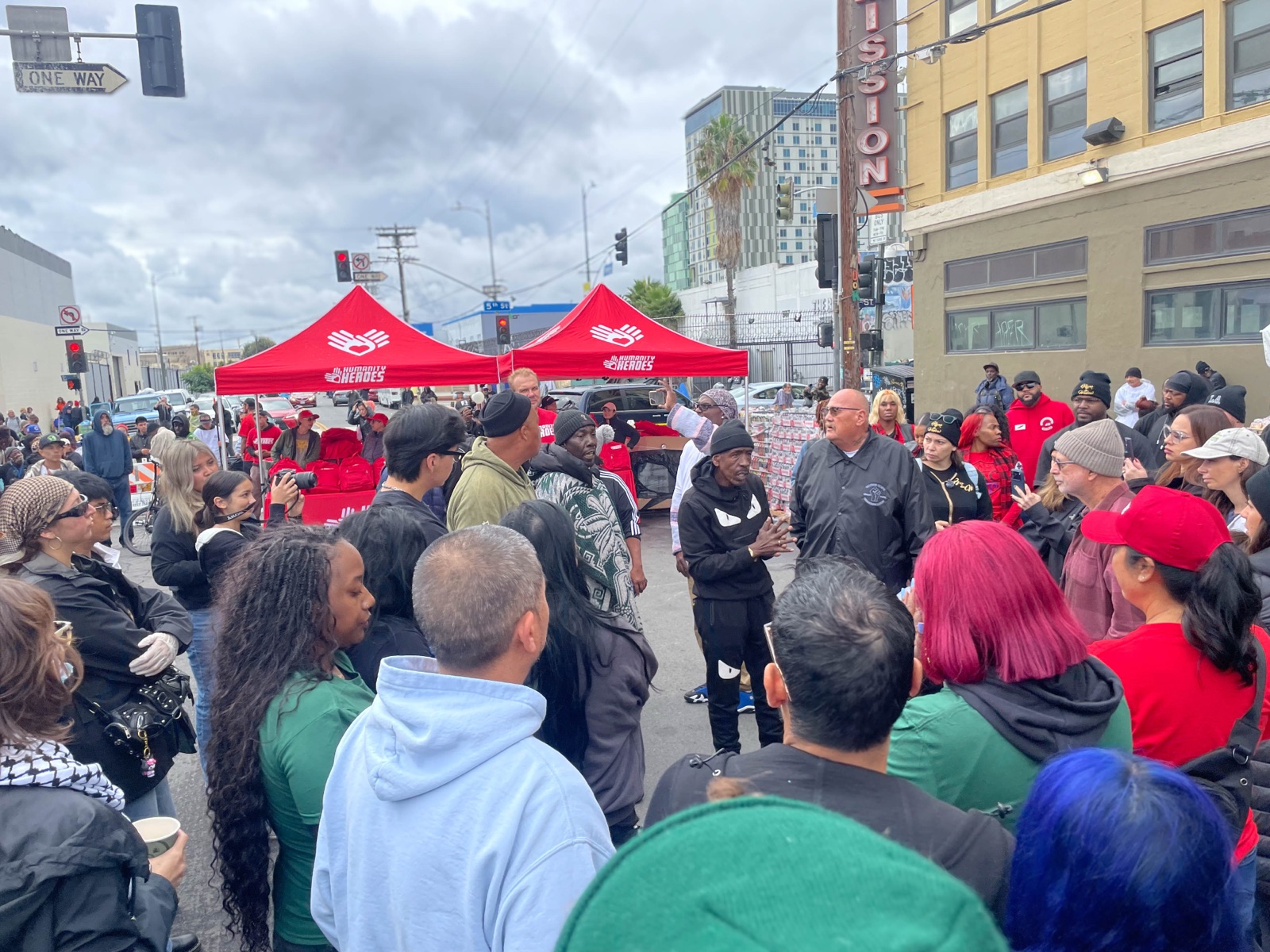 A crowd gathered around Humanity Heroes tents at a Skid Row distribution