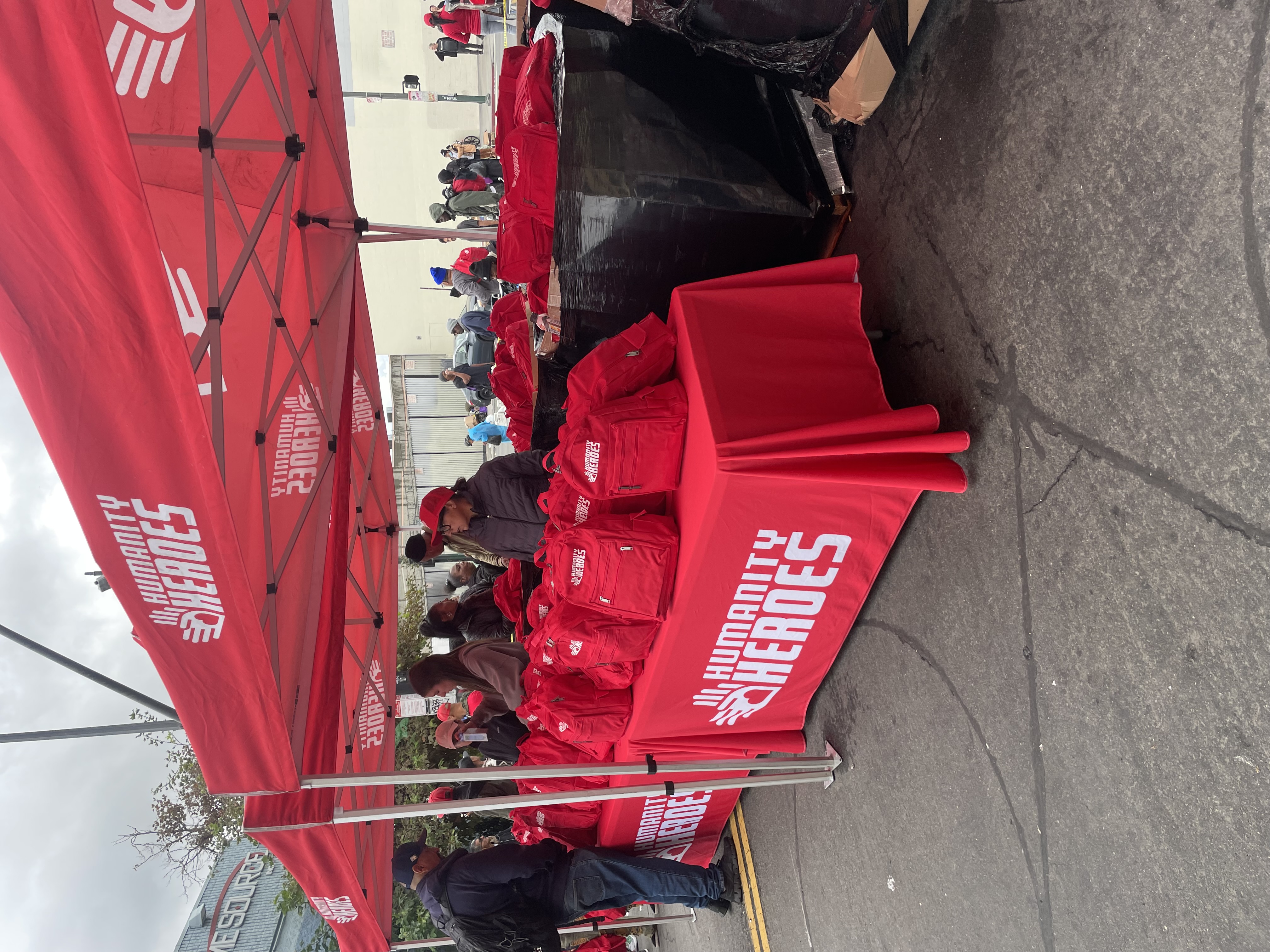 Humanity Heroes booth with backpacks ready for distribution